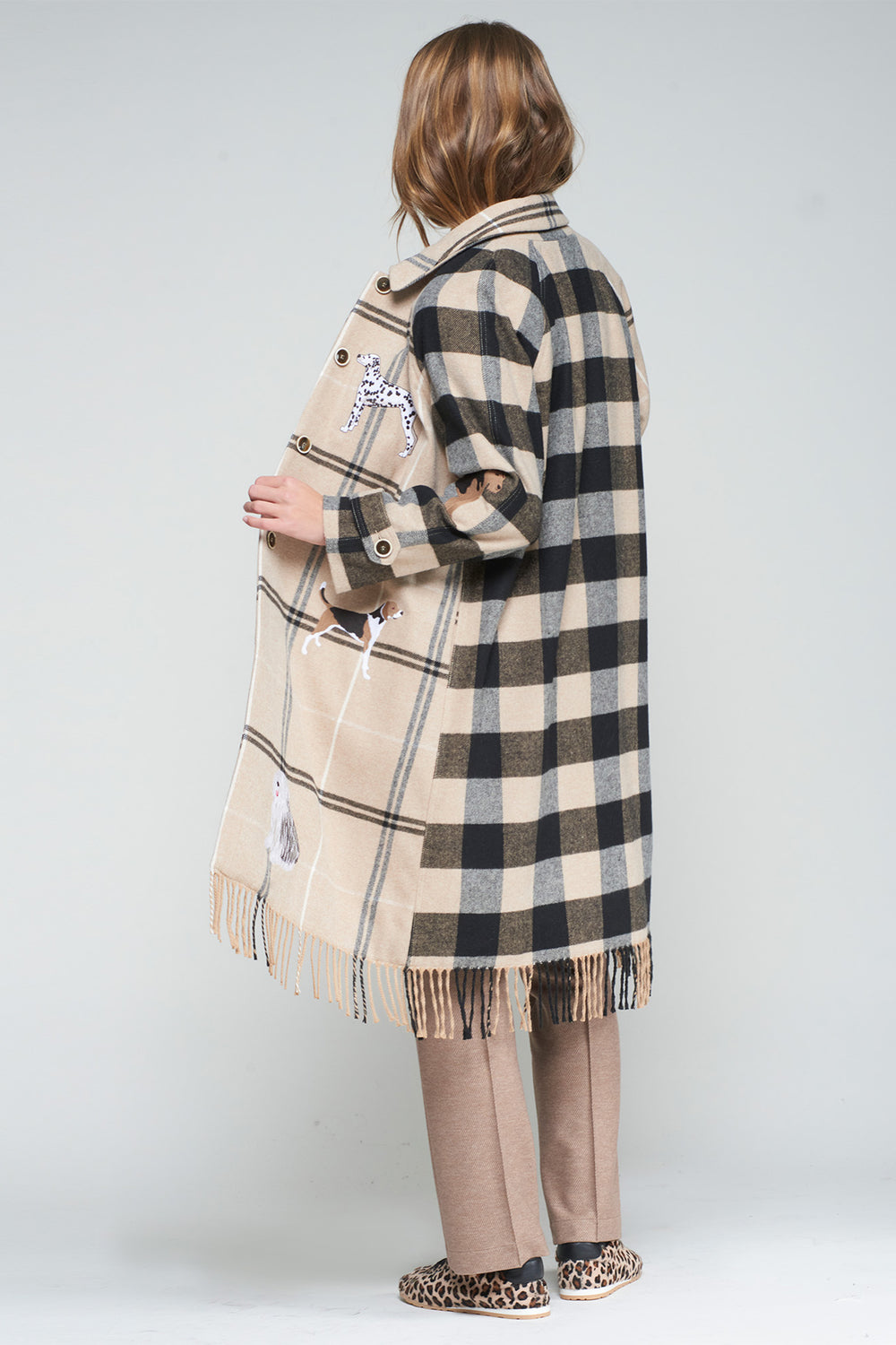 Person wearing a checkered coat with a white background