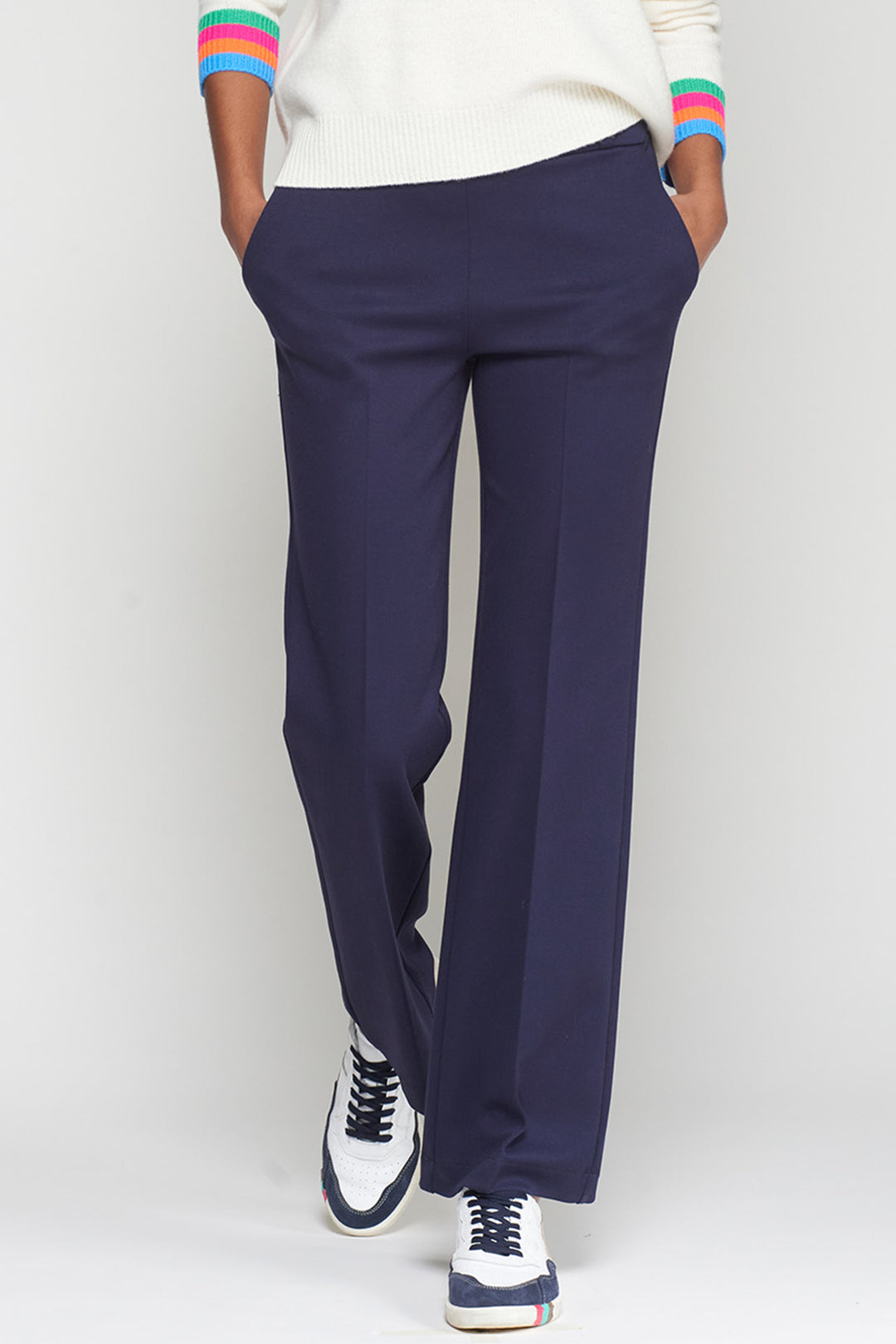 Navy blue pants worn by a person on a white background