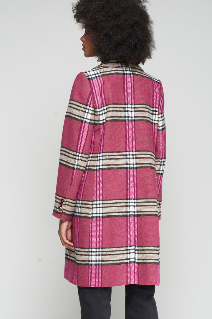 Person wearing a pink plaid coat with a white background