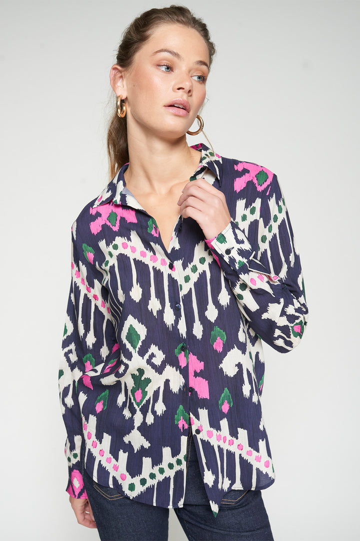 Woman wearing a patterned shirt with a white background