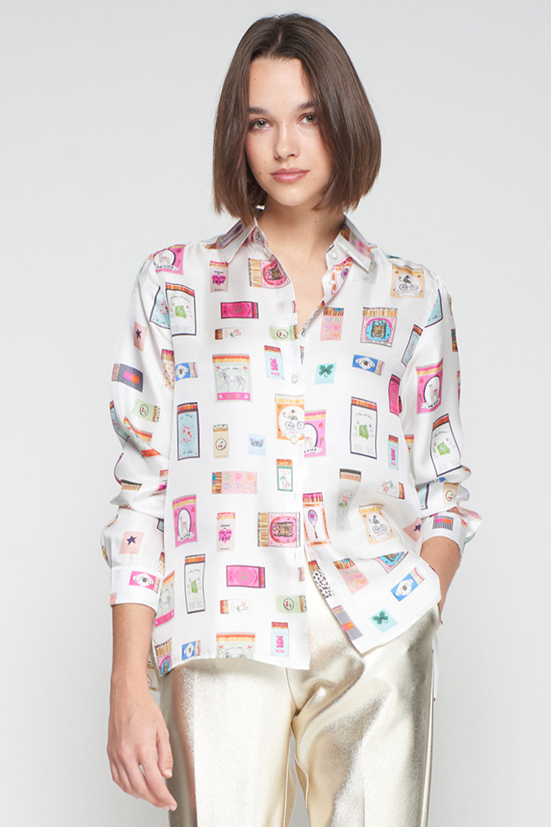 Woman wearing a colorful patterned shirt against a plain background