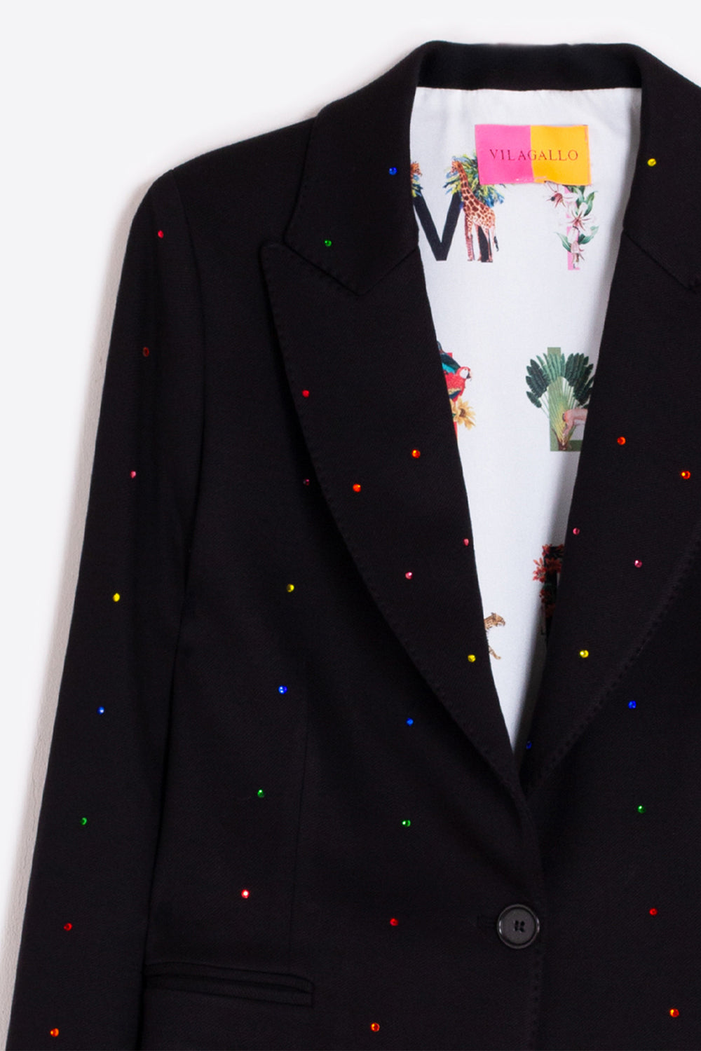 Black blazer with colorful specks on a white background