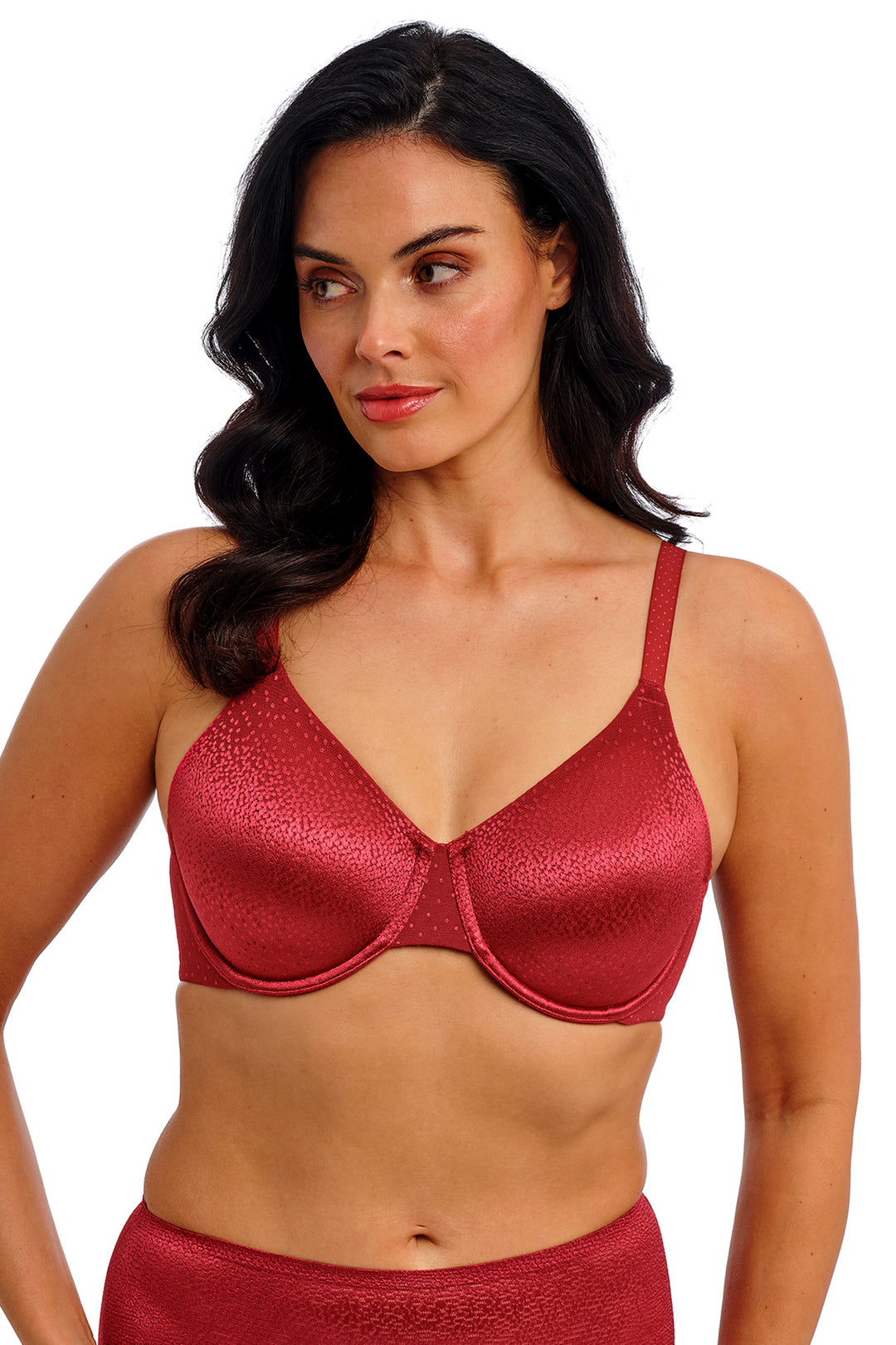 Woman wearing a red bra and panties set on a white background