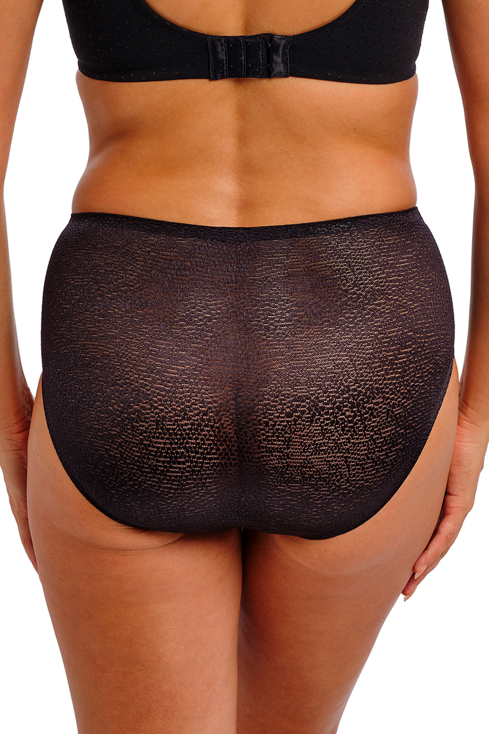 Black underwear worn by a person on a white background