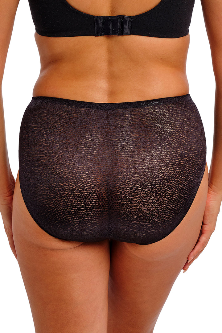 Black underwear worn by a person on a white background