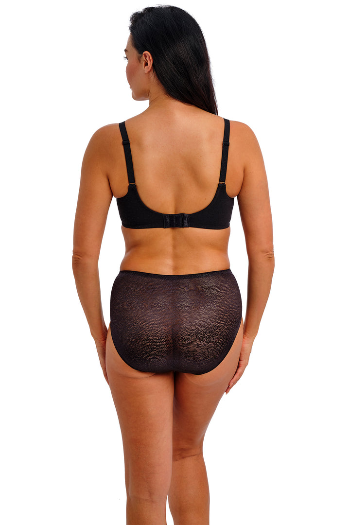 Woman wearing a black lingerie set on a white background