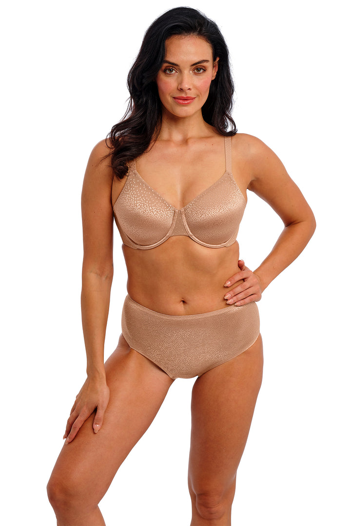 Woman wearing a beige bra and panties set on a white background
