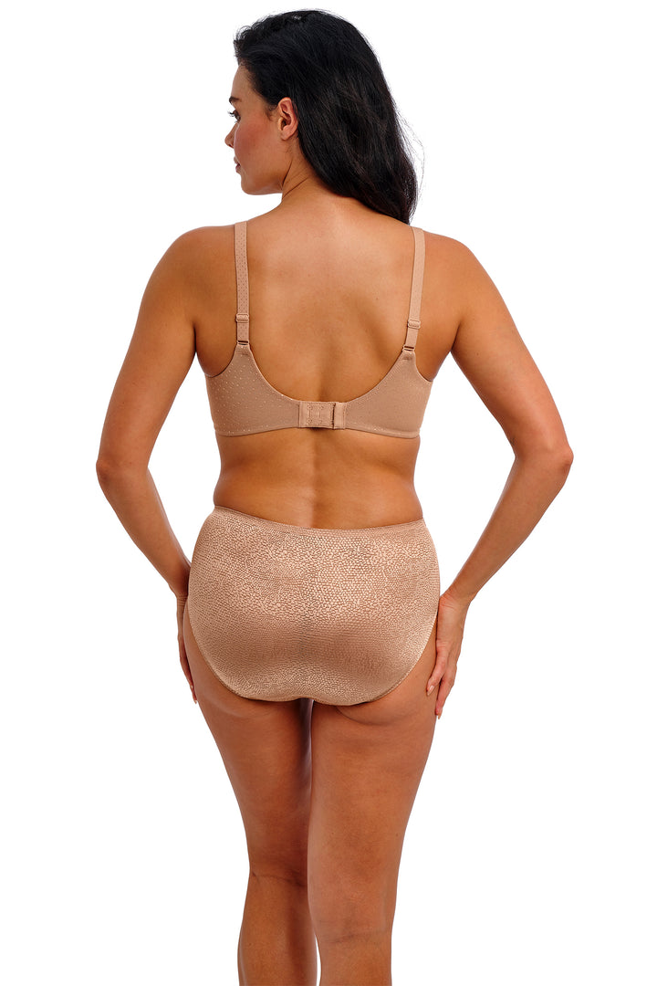 Woman wearing a beige shapewear garment on a white background