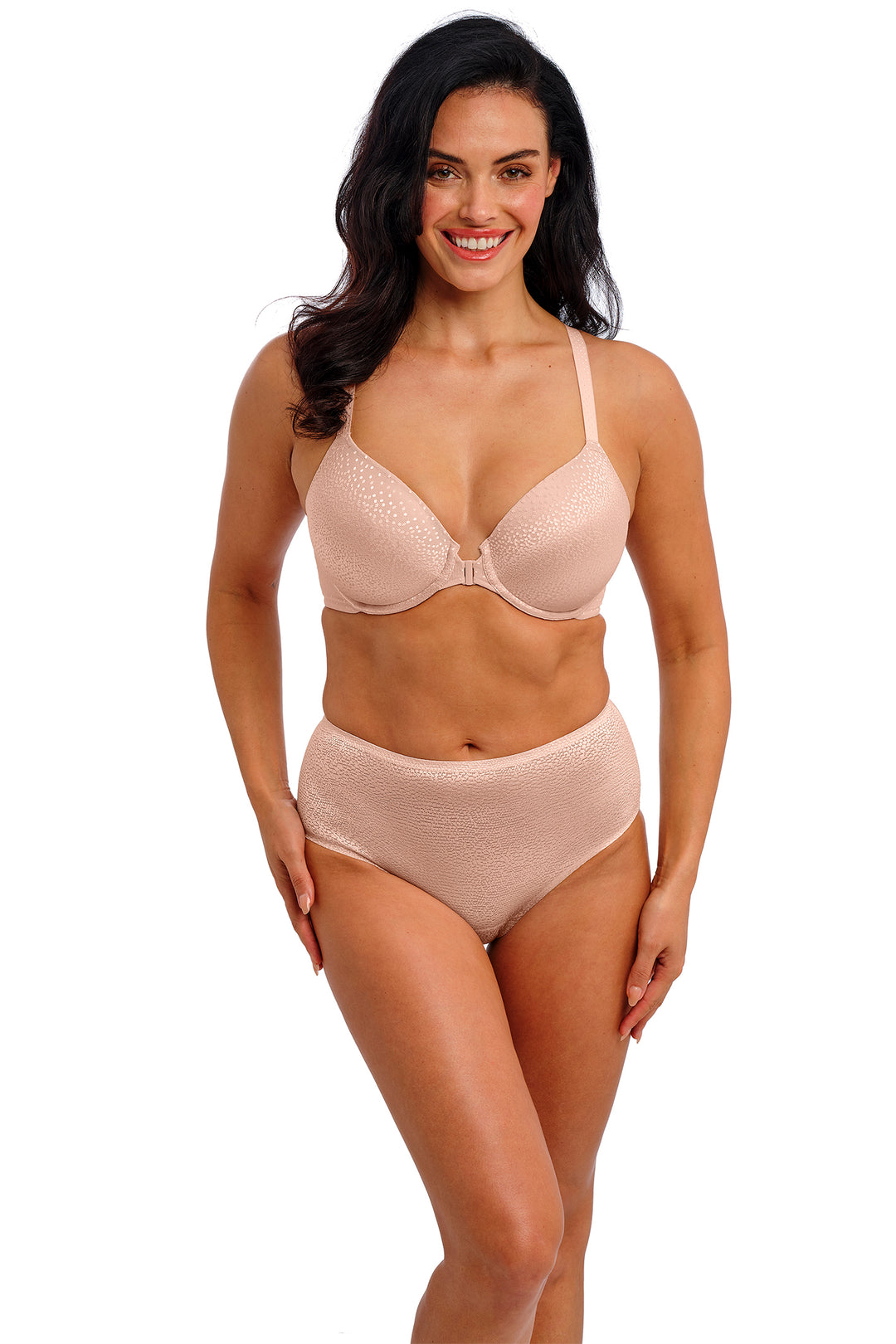 Woman wearing a pink bra and panties set on a white background
