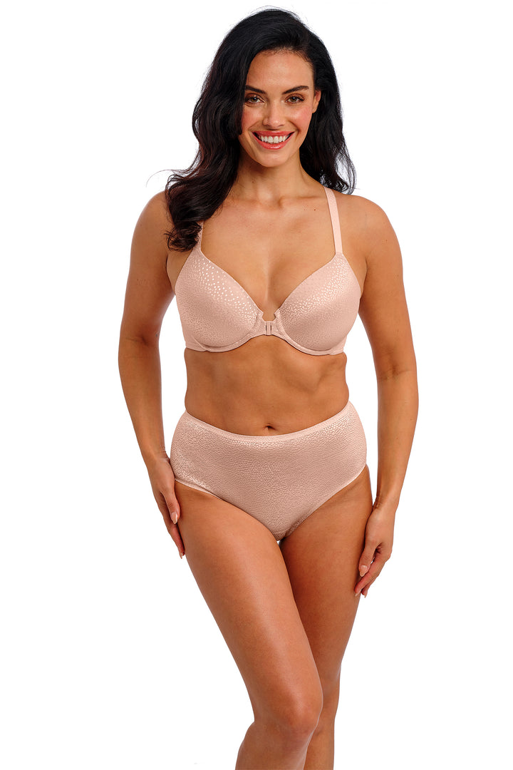 Woman wearing a pink bra and panties set on a white background