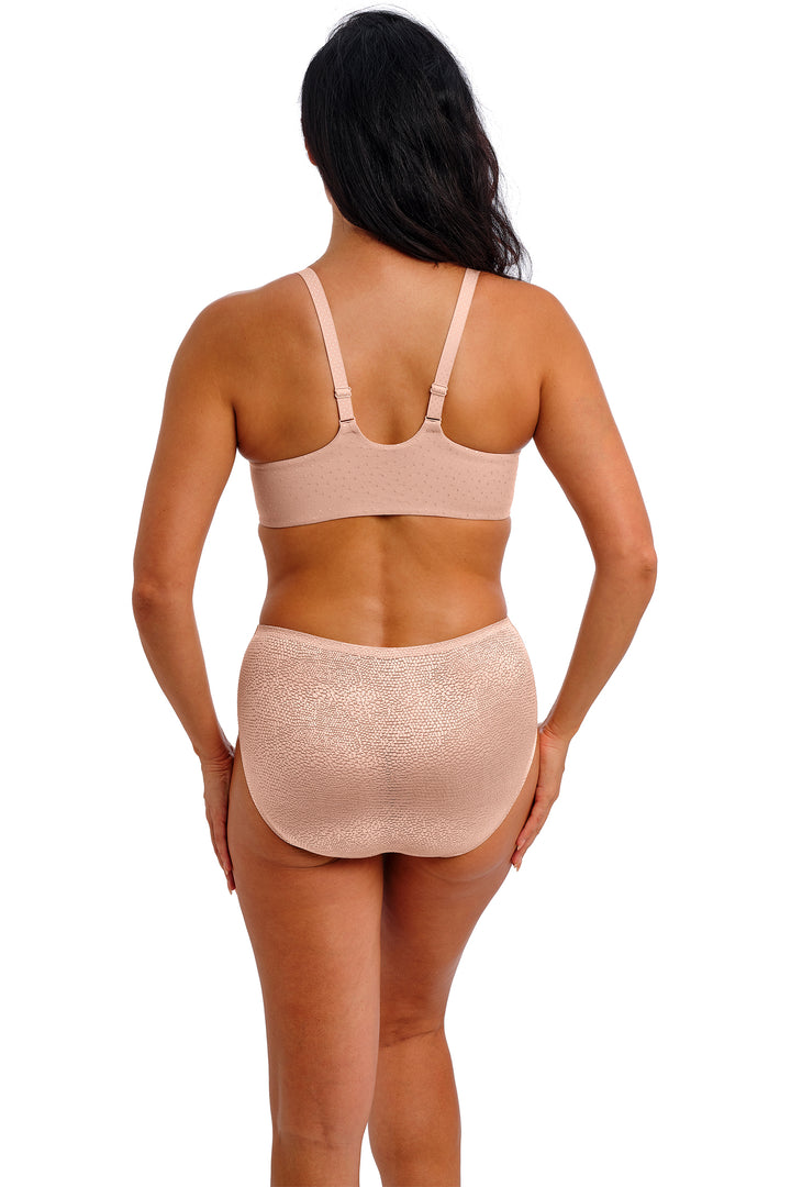 Woman wearing a pink compression garment on a white background