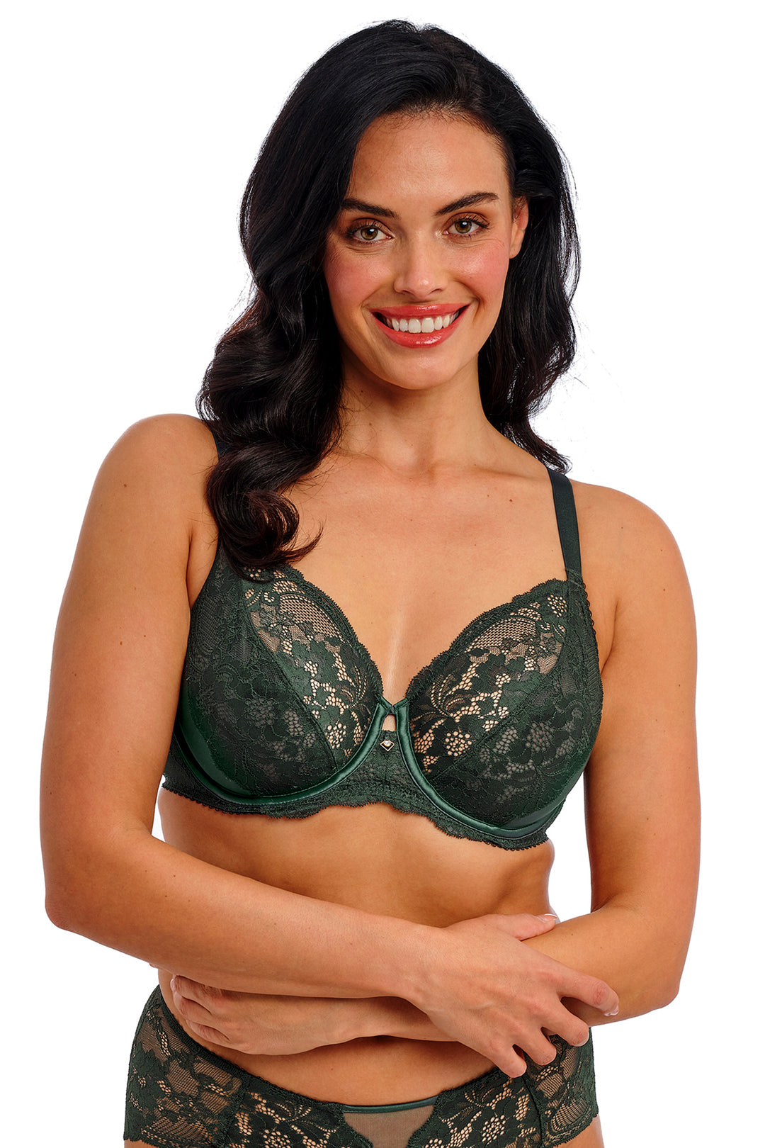Woman wearing a green lace bra and panties set on a white background