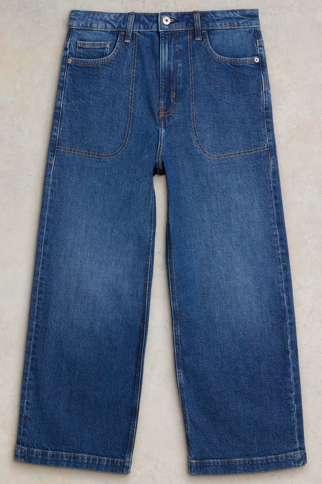 Pair of blue jeans on a light gray background