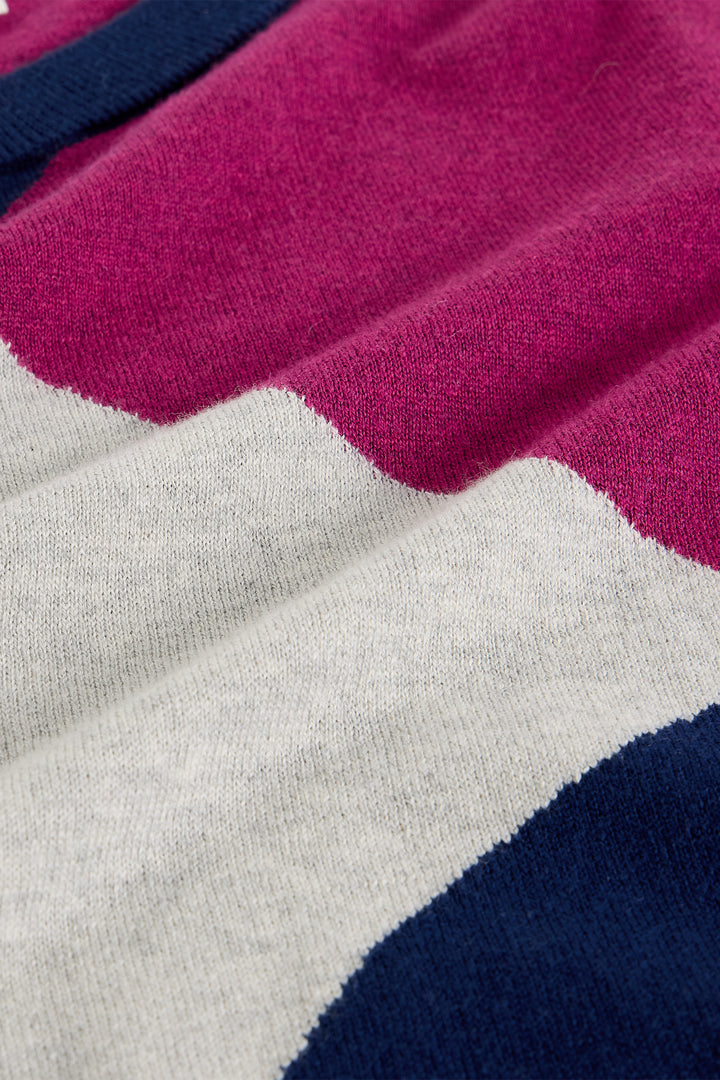 Close-up of a fabric with pink, gray, and blue color blocks.