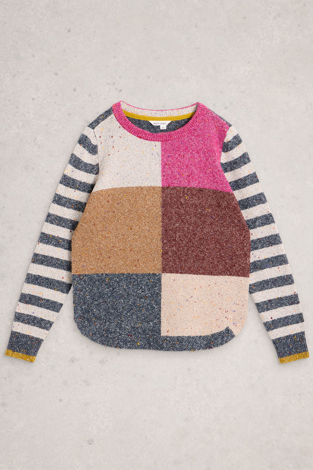 Color-blocked sweater with striped sleeves on a light gray background