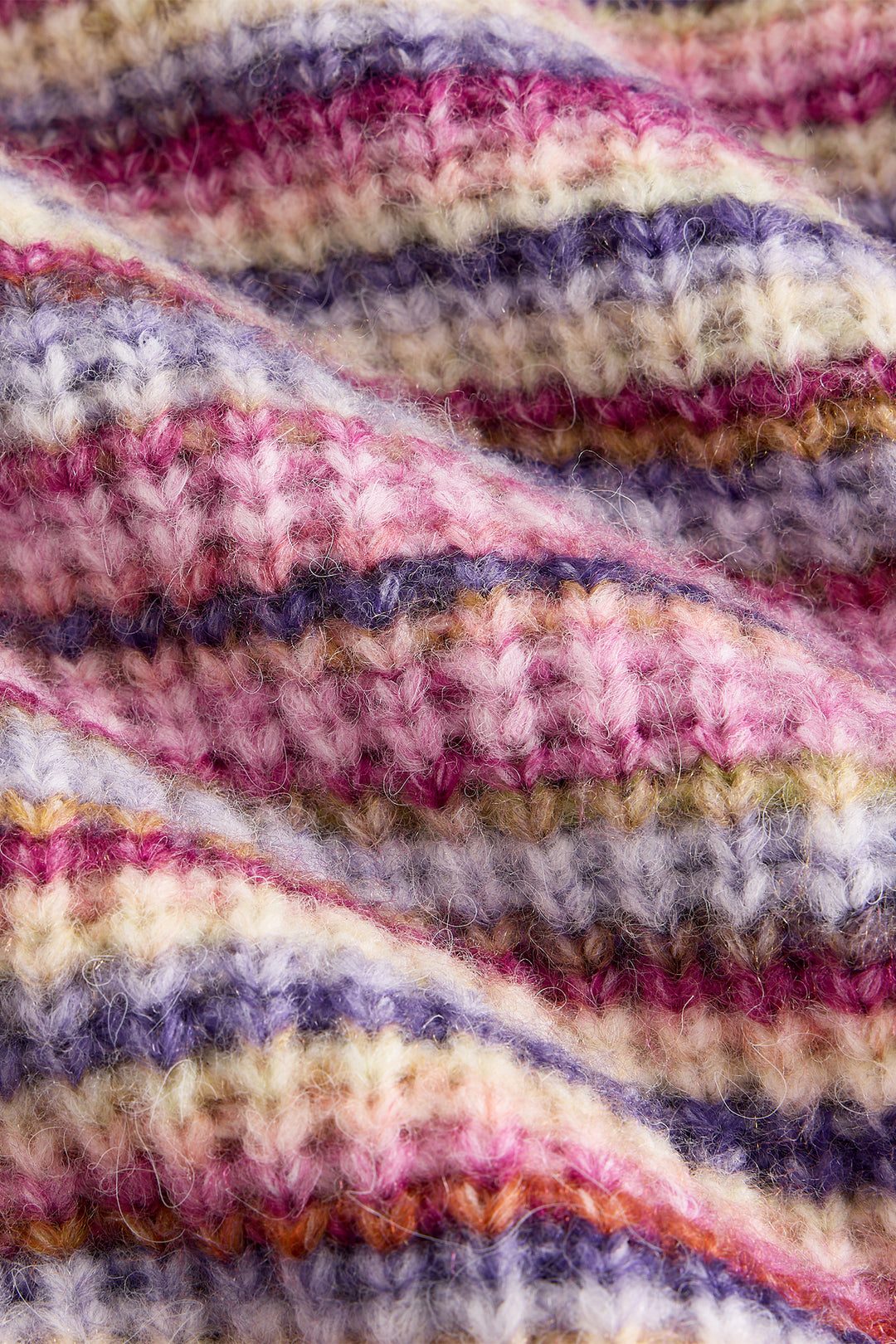 Close-up of a knitted fabric with multicolored stripes.