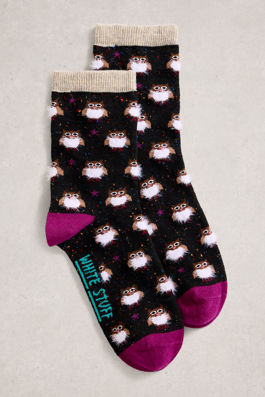 Two pairs of socks with owl pattern on a light gray background