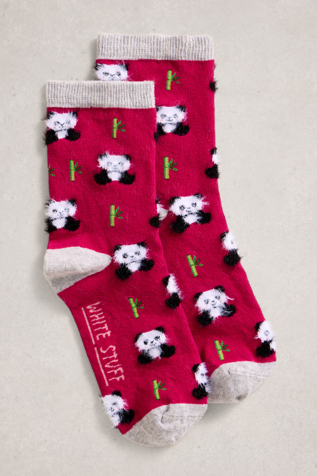 Pink socks with panda bear design on a light gray background