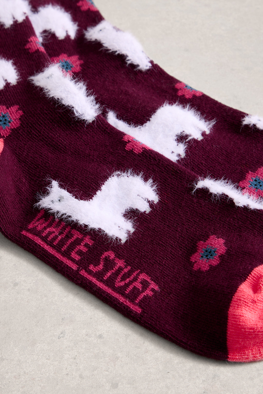 Maroon sock with white horse design and 'White Stuff' branding on a light background