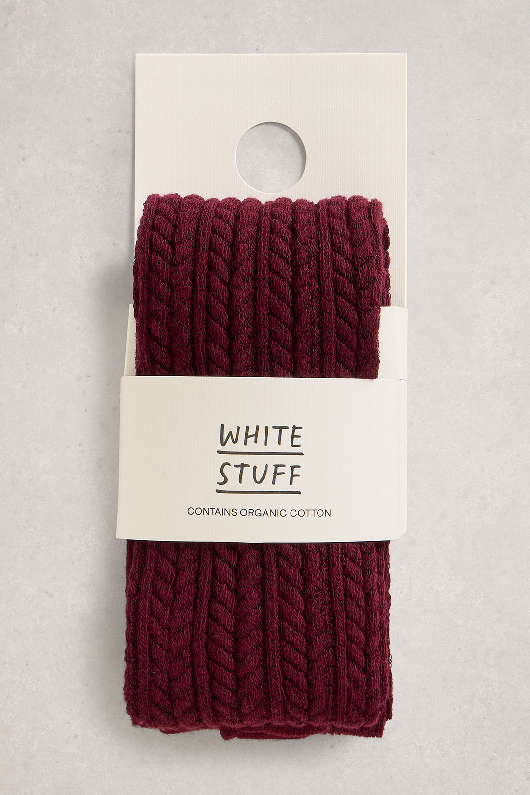 Burgundy knitted tights on a 'White Stuff' branded card against a light gray background