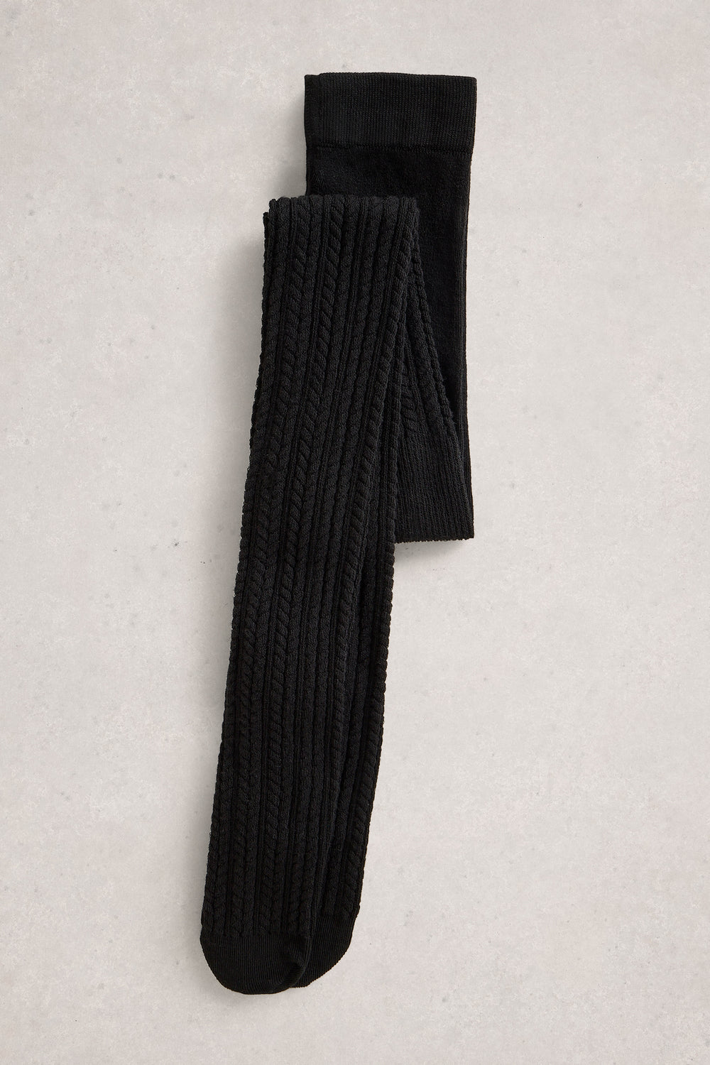 Pair of black tights on a light gray textured background