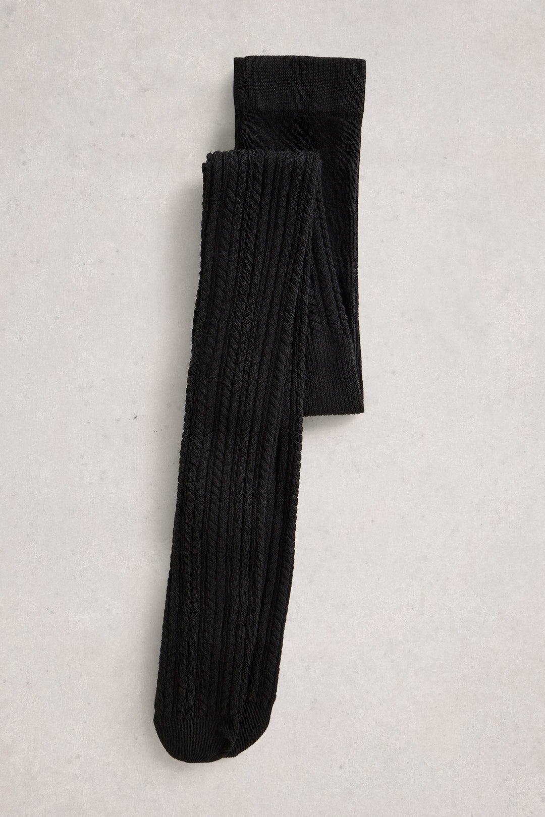 Pair of black tights on a light gray textured background