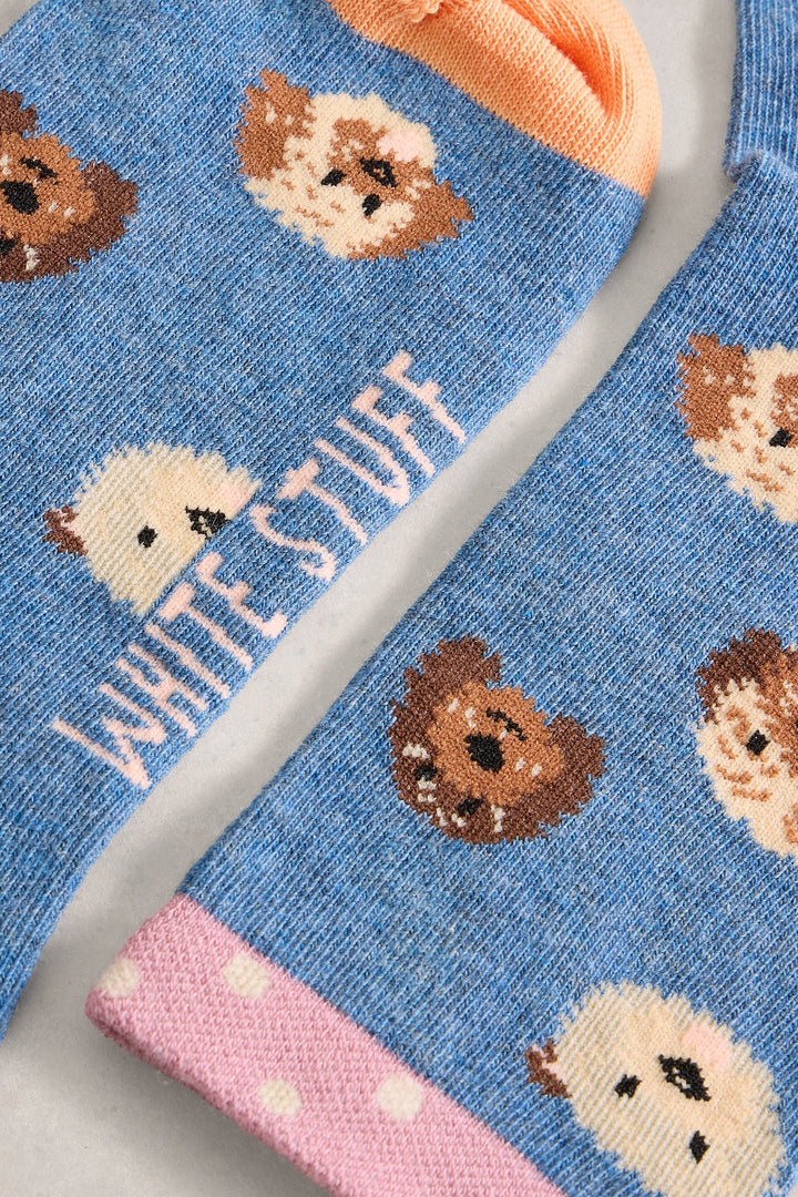 Blue socks with teddy bear pattern and 'White Stuff' branding.