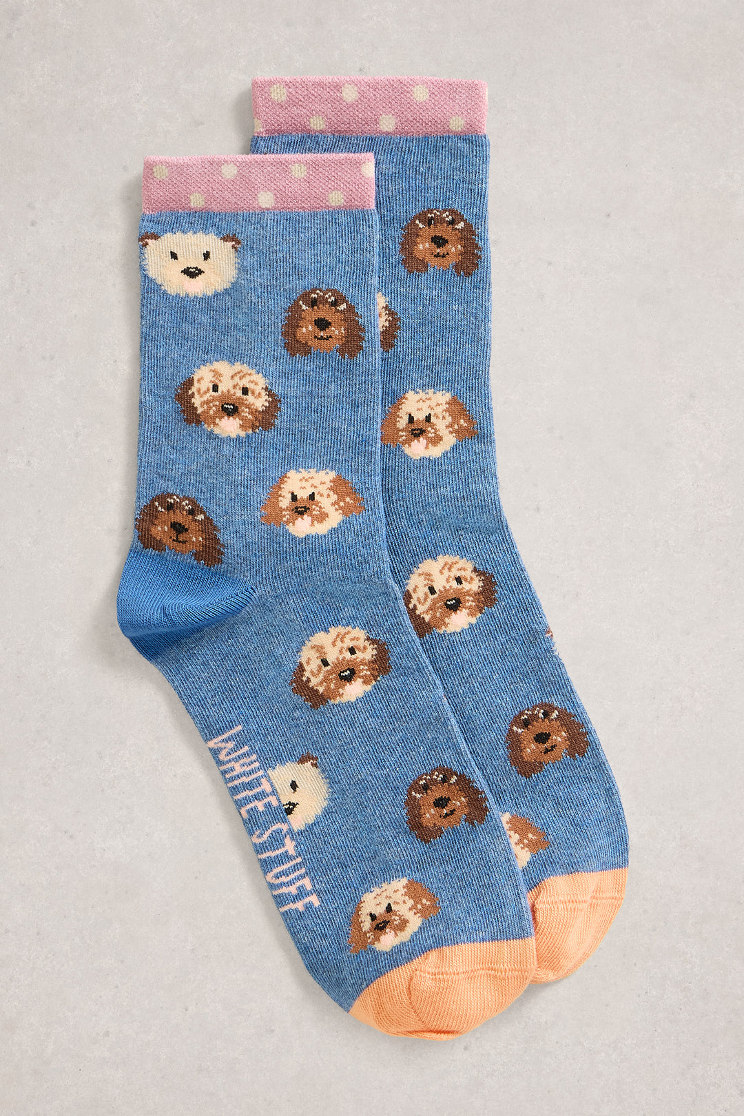 Blue socks with dog pattern on a light gray background
