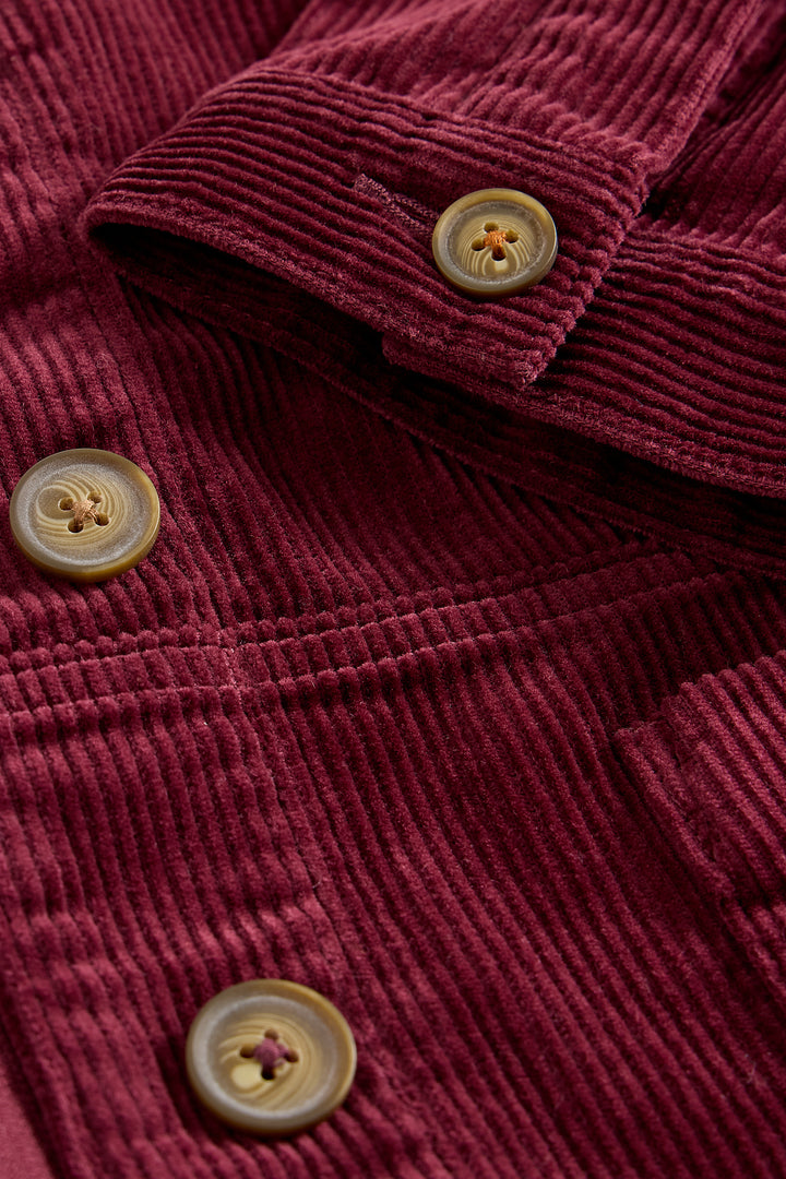 Close-up of a red corduroy jacket with buttons