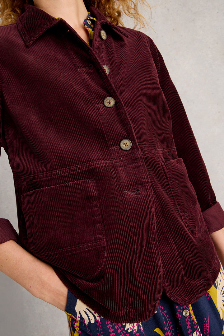 Maroon corduroy shirt worn by a person with a neutral background