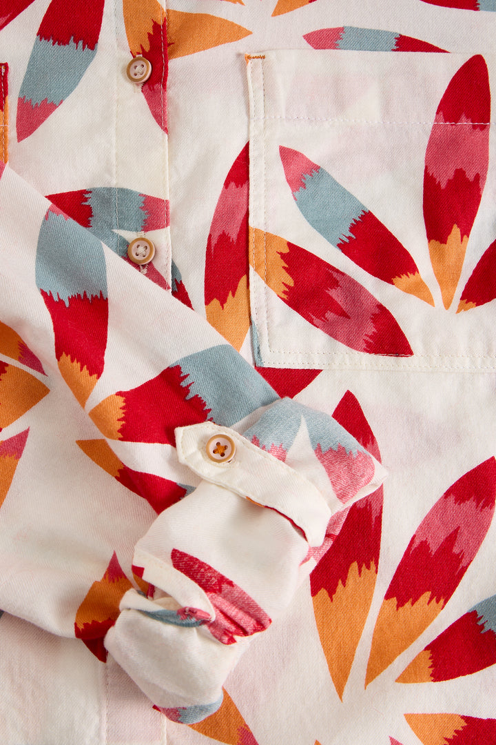 Close-up of a shirt with a colorful geometric pattern on a white background