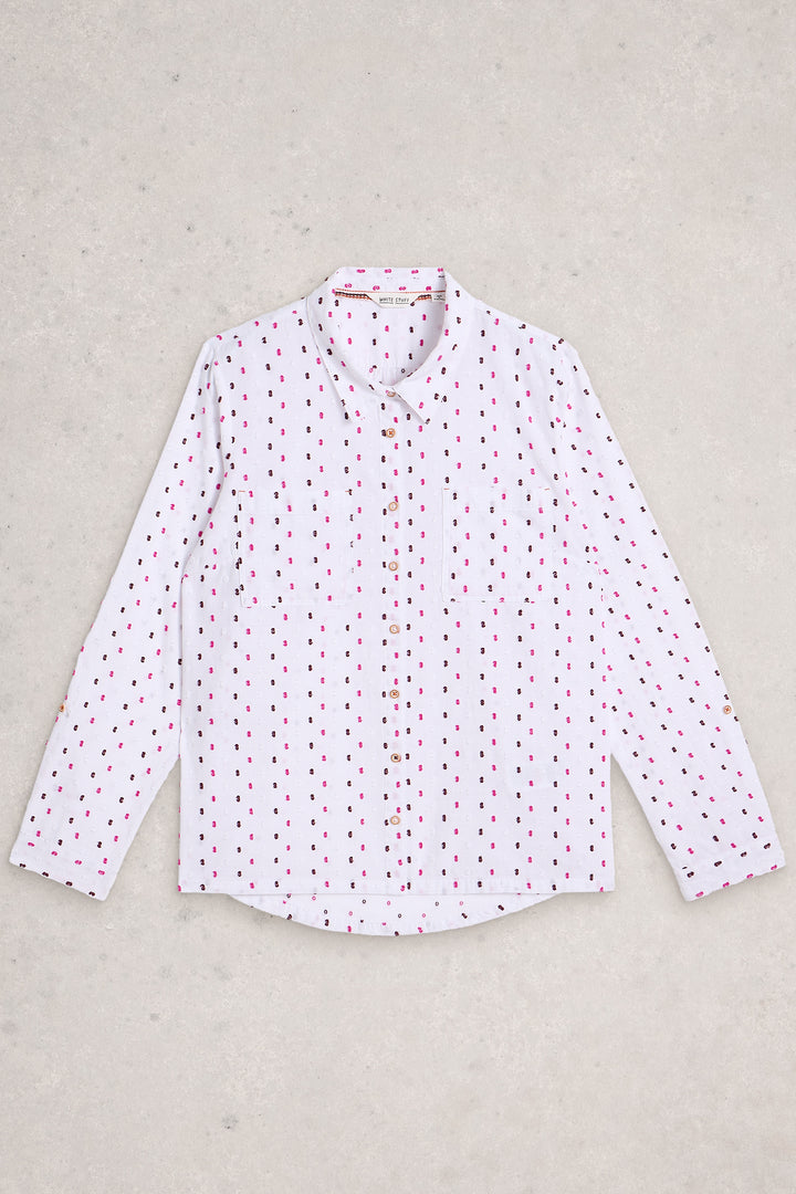White shirt with red pattern on a beige background