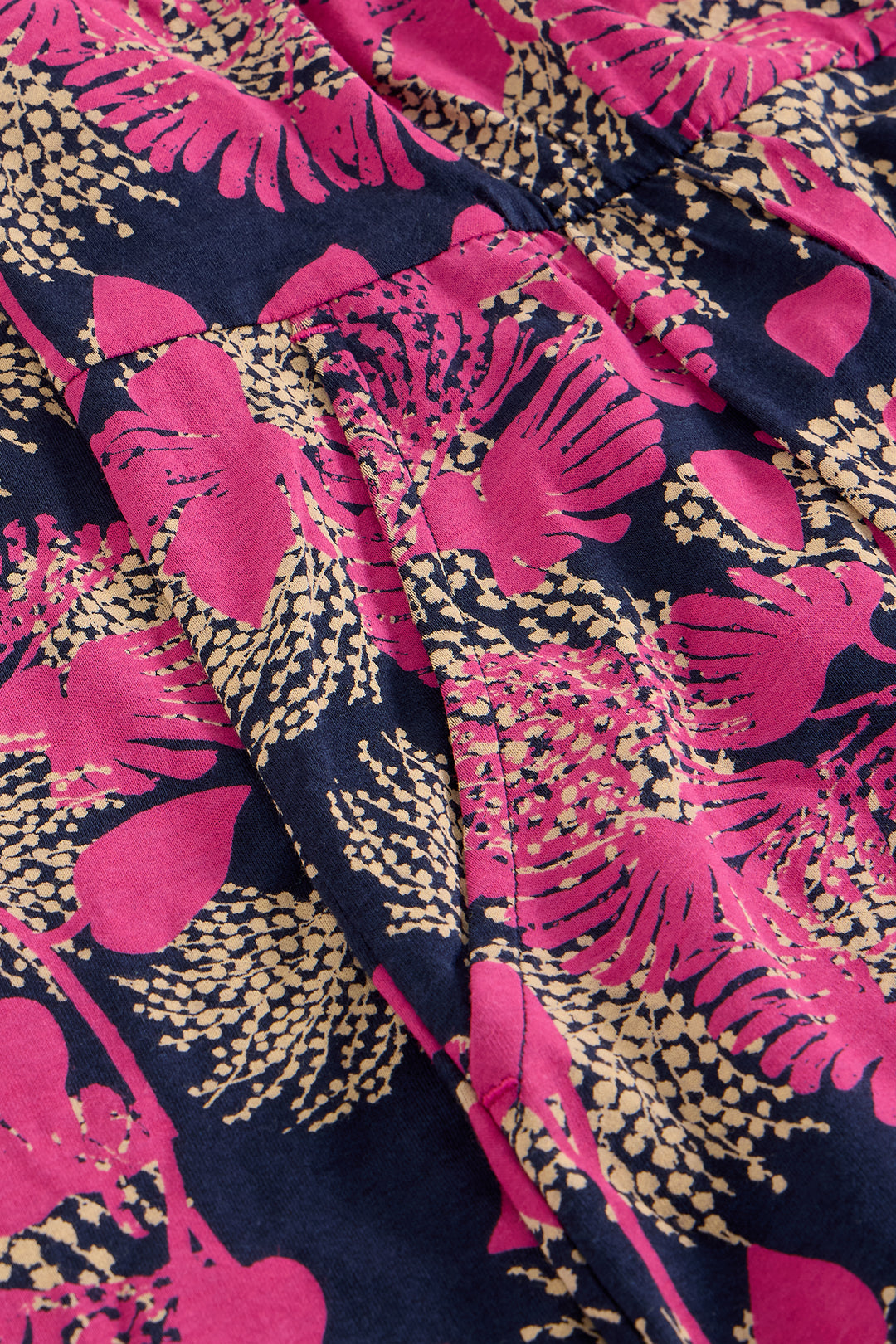 Close-up of fabric with pink floral pattern on a dark background
